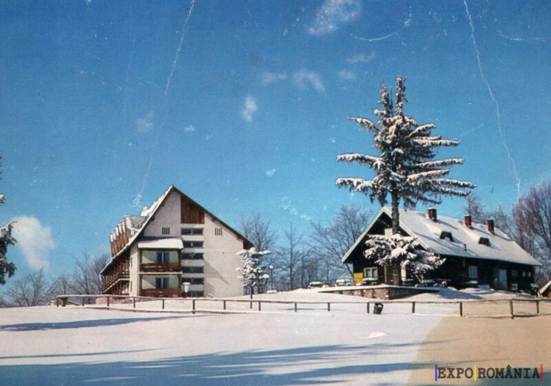 Peisaj de iarnă cu cabane înzăpezite
